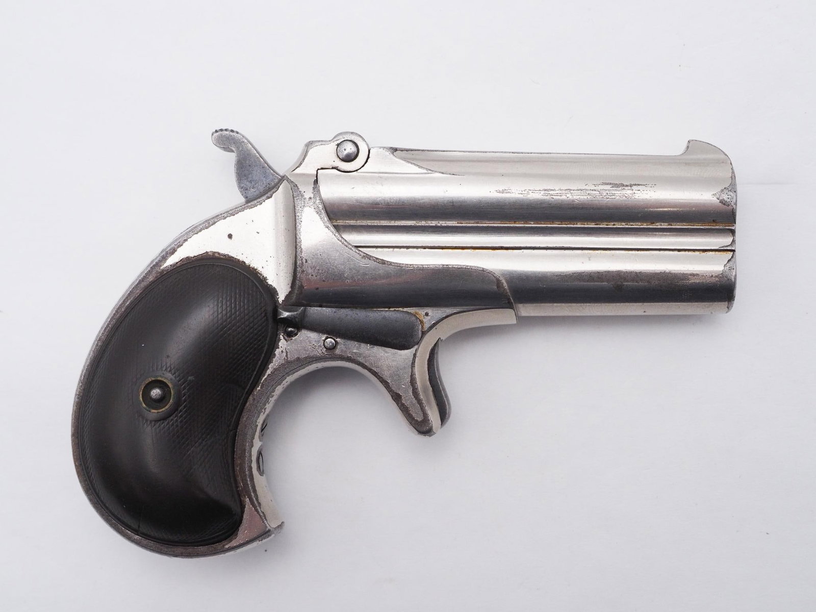 Remington Double Derringer Pistol: SN: 973 Cal: .41 Cal Action Type: Over Under Derringer Barrel Length: 3" Sights/Optics: Original Sights Stock: Original grips, right side has a small crack Finish: Nickel Finish Cond: Original, some