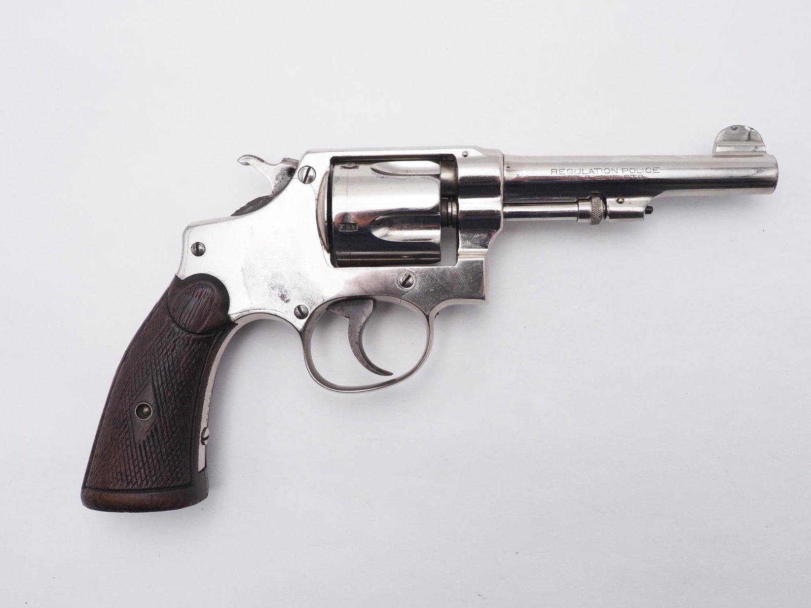 Smith & Wesson Regulation Police Revolver: SN: 16056 Cal: .38 S&W Action Type: Double Action Barrel Length: 4" Sights/Optics: Original sights Stock: Factory wood grips marked "PAT. JUNE 5 1917" on butt Finish: Nickel Finish Cond: