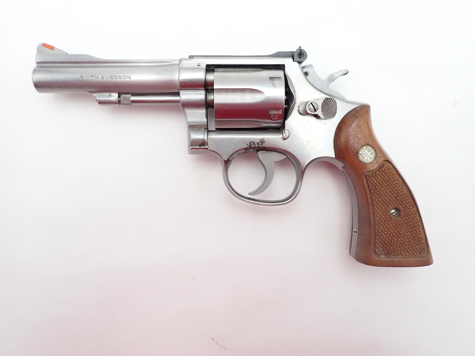 Smith & Wesson 67-1 Revolver: SN: 94K5502 Cal: .38 Special Action Type: Double Action Barrel Length: 4" Sights/Optics: Adjustable rear and red ramp front Stock: Original factory wood grips Finish: Stainless