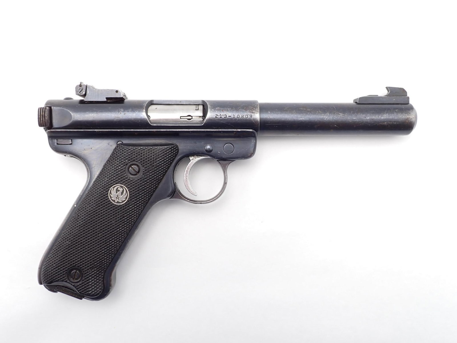 Ruger Mark II Pistol: SN: 213-10809 Cal: .22 LR Action Type: Semi Auto Barrel Length: 5.5" Bull barrel Sights/Optics: Factory target sights Stock: Black plastic factory grips Finish: Blued Finish Cond: Worn Bore: Good
