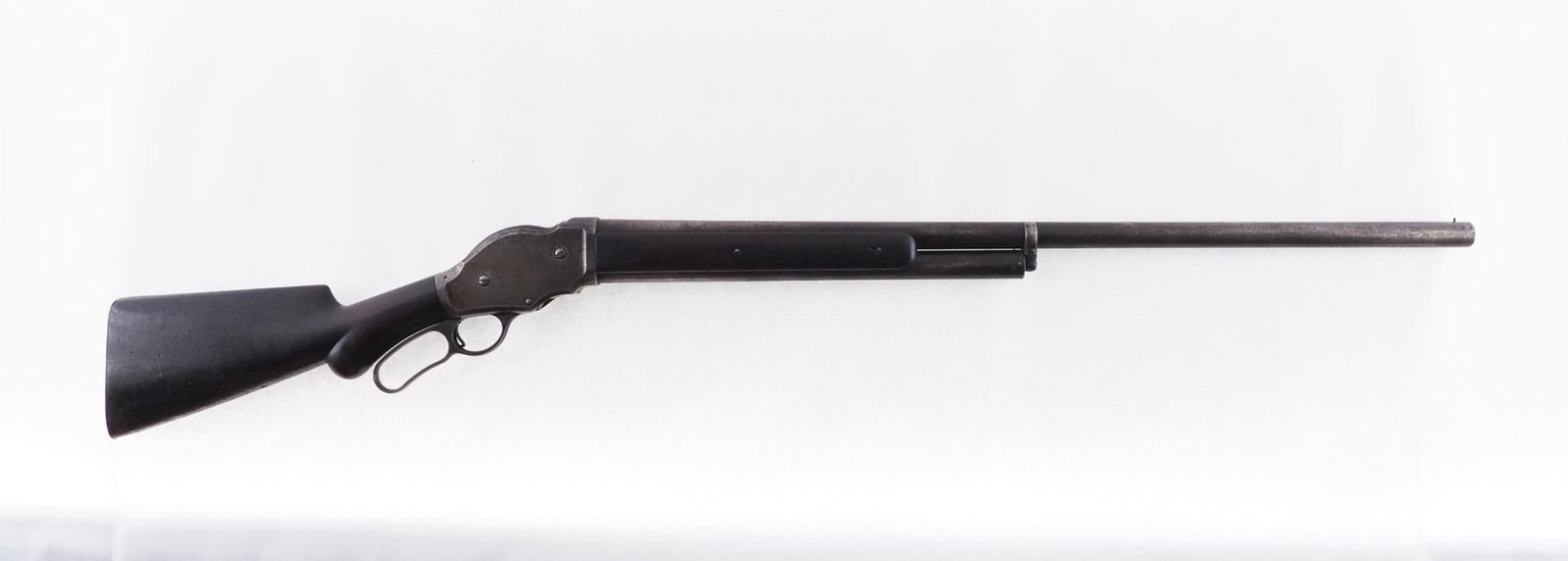 Winchester 1887 Shotgun: SN: 23171 Year of Mfg: 1889 Cal: 12 Ga. Action Type: Lever Action Barrel Length: 31.5" Sights/Optics: Front bead sight Stock: Original wood, small crack at tang Finish: Blued Finish Cond: Most bluing