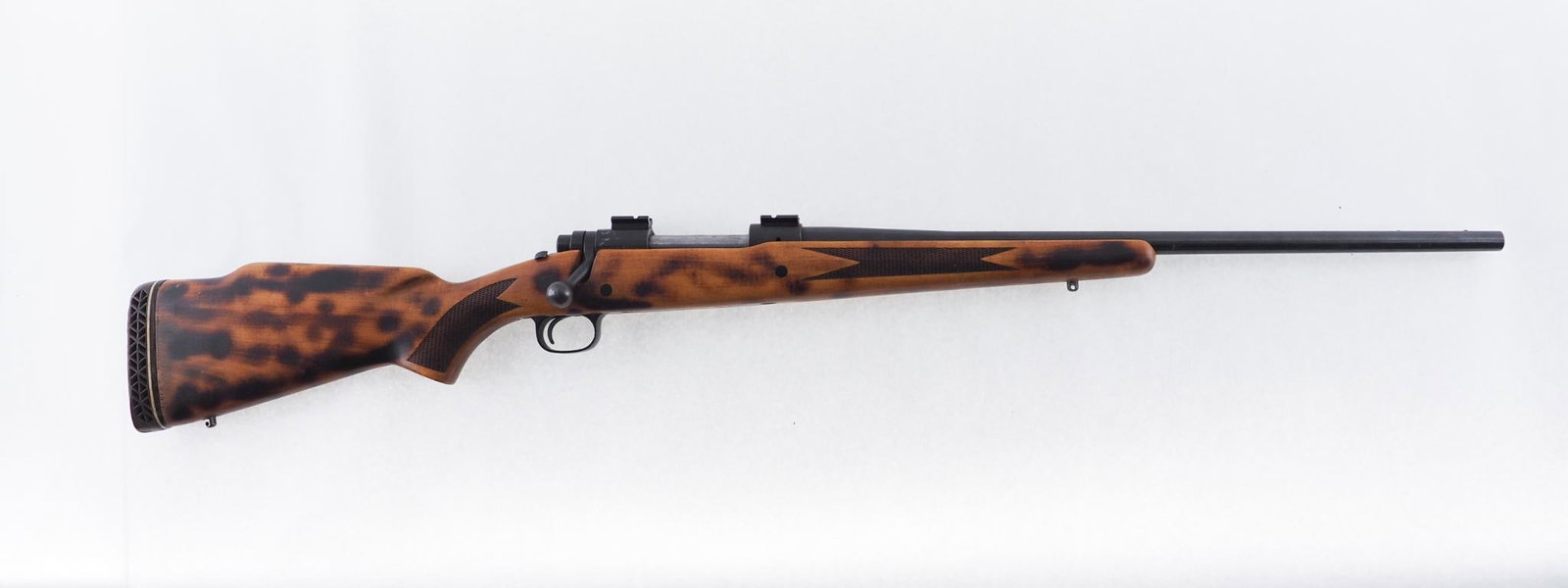 Winchester Model 670 Rifle: SN: 127406 Cal: .30-06 Action Type: Bolt Action Barrel Length: 22" Sights/Optics: Weaver scope bases Stock: Original wood stock, added recoil pad, and torch finish pattern added to wood F