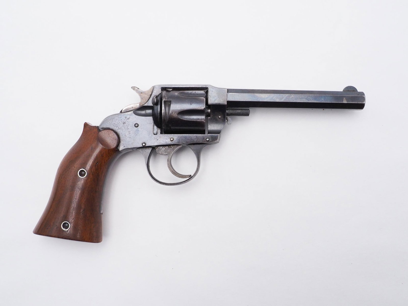 Hopkins & Allen Range Model Revolver: SN: A3832 Cal: .32 CF Action Type: Double Action Barrel Length: 4.5" Sights/Optics: Factory fixed sights Stock: Original wood grips Finish: Blued Finish Cond: Original Bore: Good Overall Cond: Good