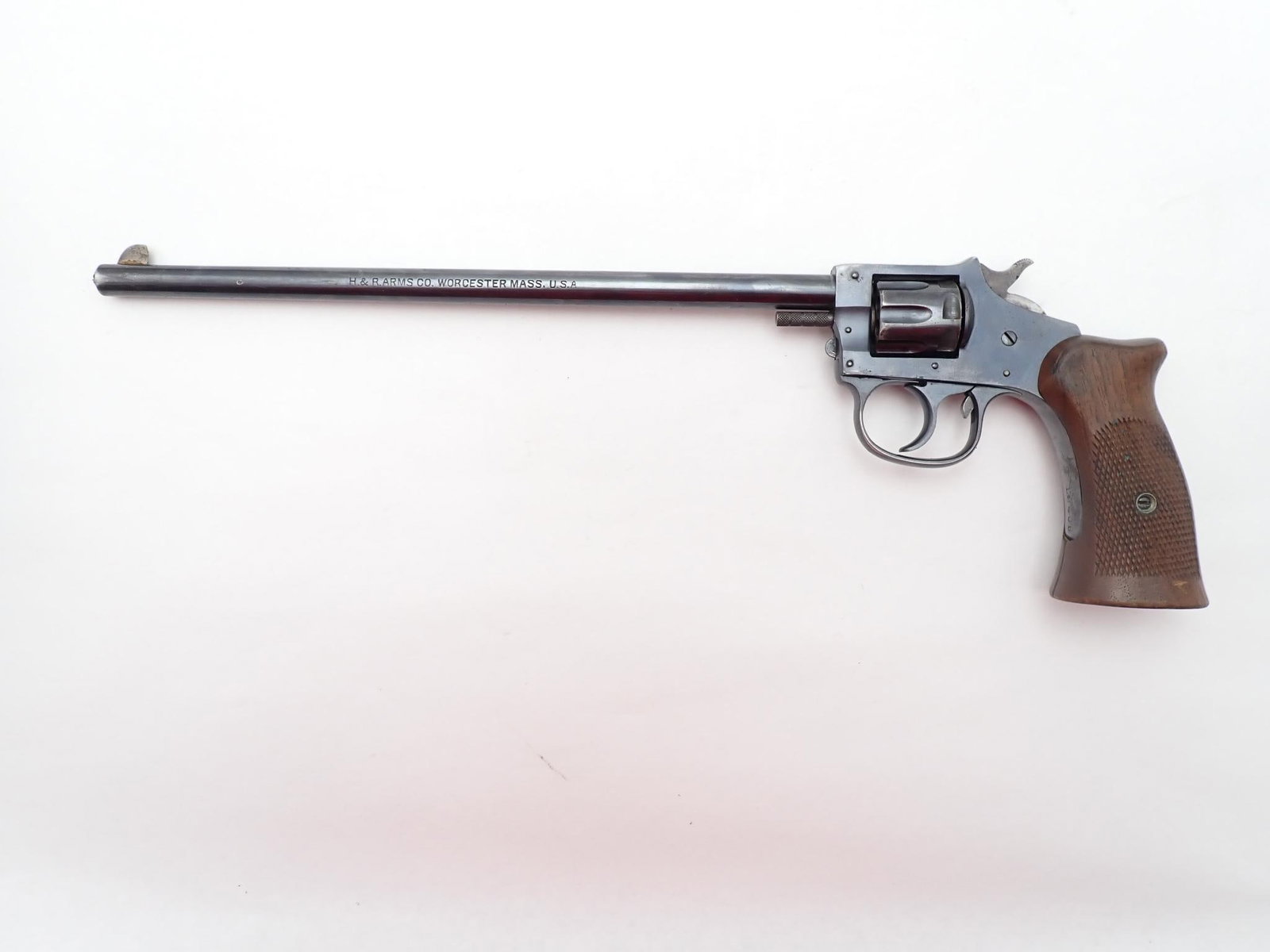 Harrington and Richardson Hunter Revolver: SN: 138408 Cal: .22 LR Action Type: Double Action Barrel Length: 10" Sights/Optics: Factory open sights Stock: Original wood grips Finish: Blued Finish Cond: Some holster wear Bore: Excellent Overall