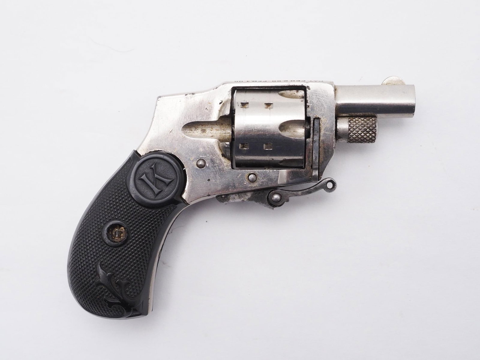 Kolb 1910 Baby Hammerless Revolver: SN: 984 Year of Mfg: 1910-1924 Cal: .22 Short Action Type: Double Action Barrel Length: 1.25" Sights/Optics: Original sights Stock: Original bakelite black grips, left side is chipped Finish: Nickel