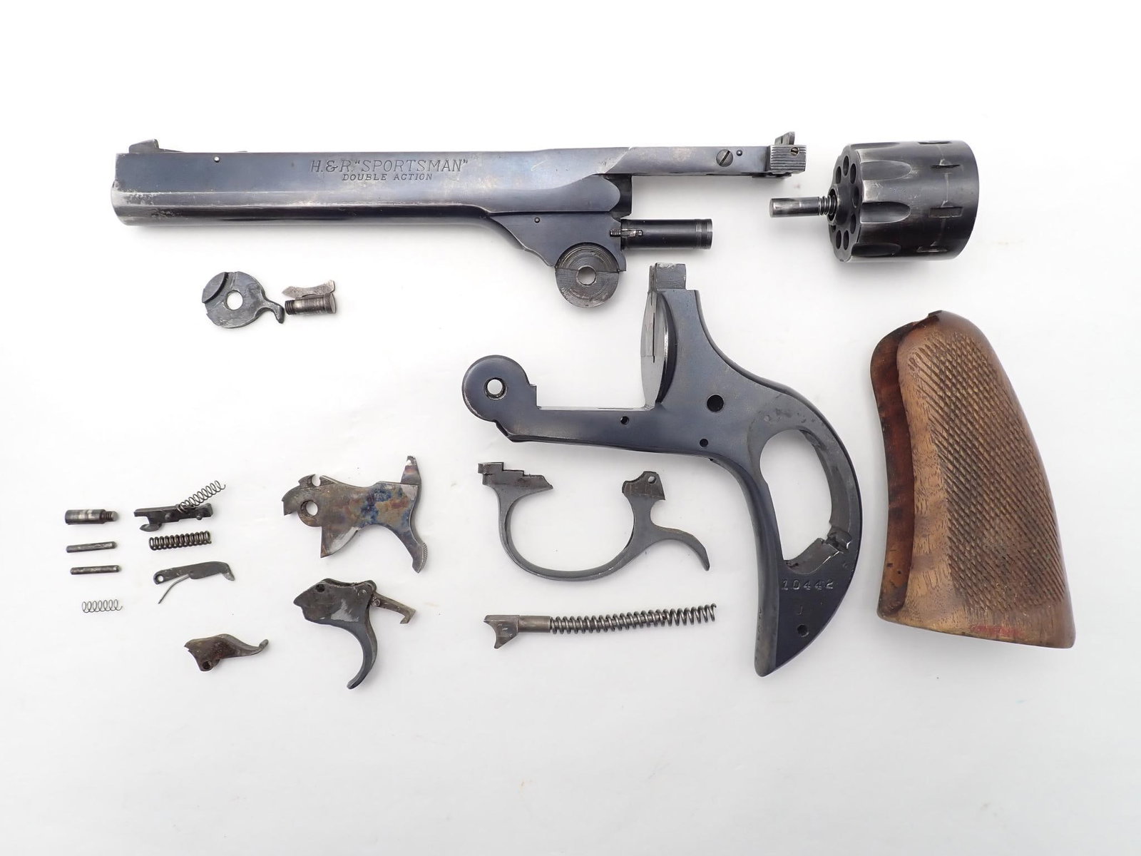 Harrington and Richardson Sportsman Revolver: SN: A10442 Year of Mfg: 1932-1986 Cal: .22 LR Action Type: Double Action Barrel Length: 6" Sights/Optics: Factory sights Stock: Wood grips Finish: Blued Finish Cond: Original, some holster wear Bore:
