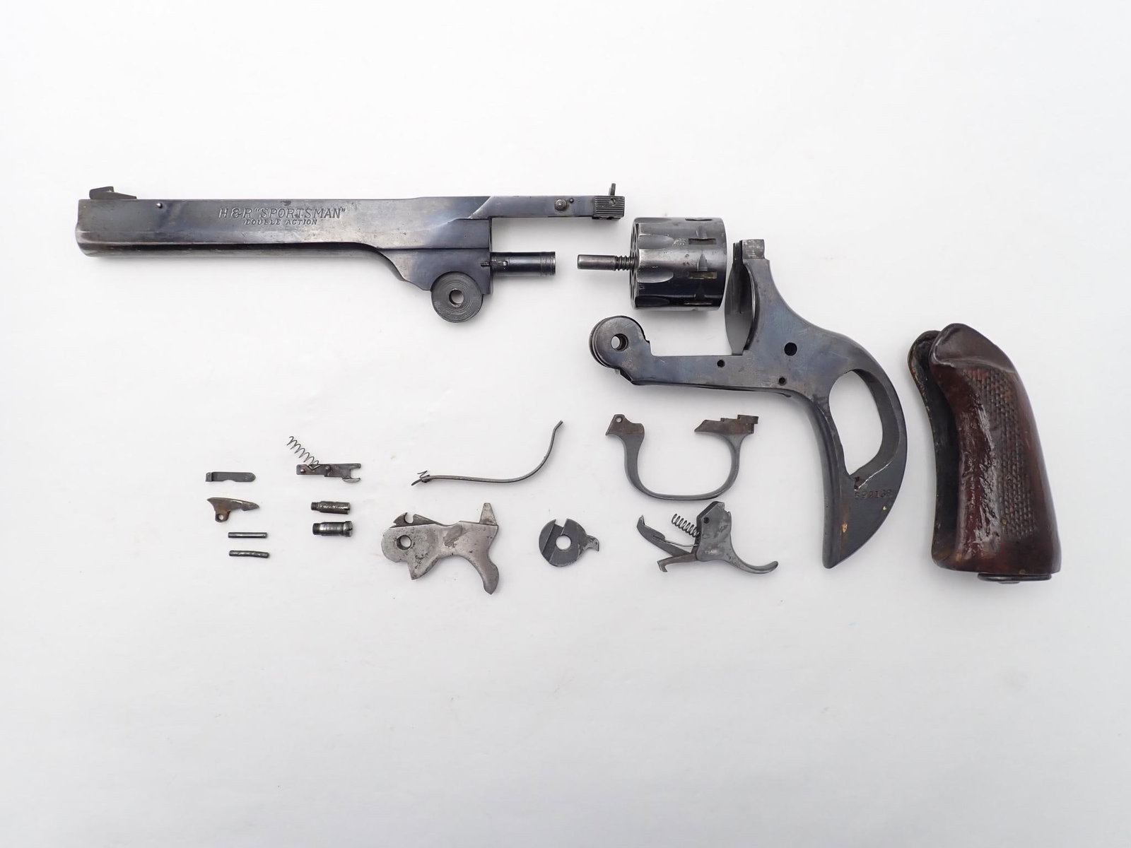 Harrington and Richardson Sportsman Revolver: SN: R592138 Year of Mfg: 1932-1986 Cal: .22 LR Action Type: Double Action Barrel Length: 6" Sights/Optics: Factory sights Stock: Wood grips Finish: Blued Finish Cond: Original, some holster wear
