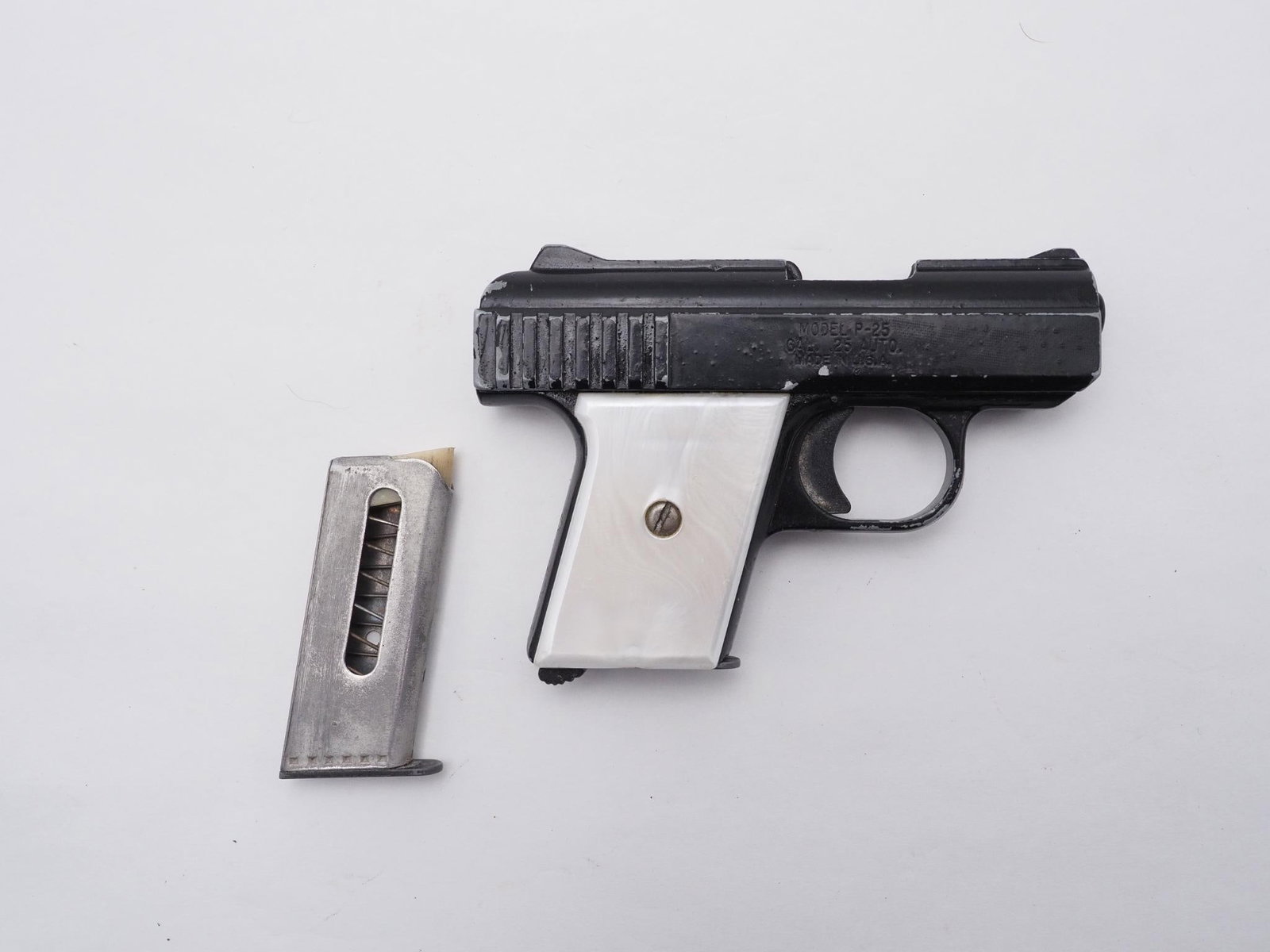 Raven Arms P-25 Pistol: SN: 7630 Cal: .25 ACP Action Type: Semi Auto Barrel Length: 2.25" Sights/Optics: Original Stock: Faux pearl grips Finish: Black paint Finish Cond: Original Bore: Good Overall Cond: Good Mechanical: