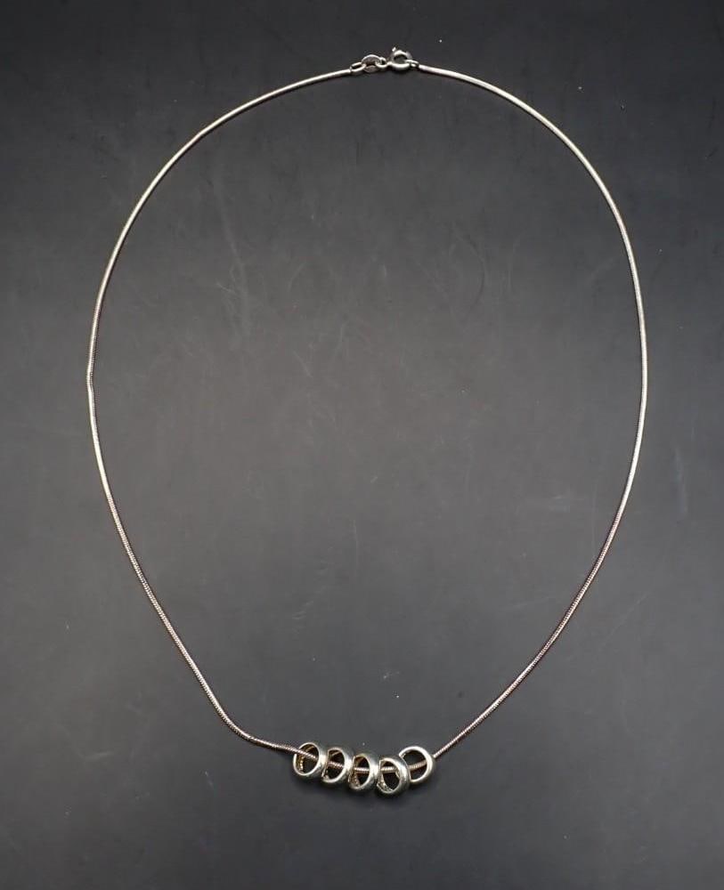Sterling Silver Hoops Necklace: 18" in length, (5) 8.75mm hoops, 9.2 grams