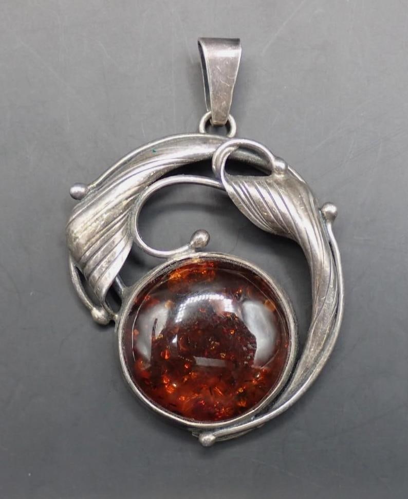 Sterling Silver and Amber Pendant: 40mm in height, 22mm diameter amber, 13.3 grams total weight