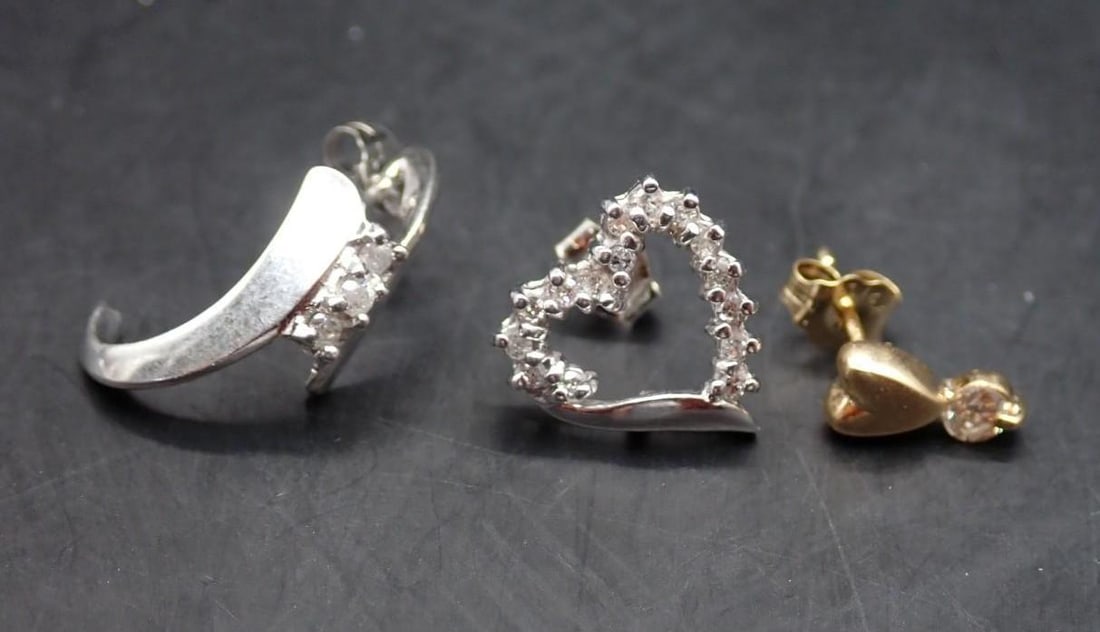 (3) Gold Stud Earrings: (1) 10K white gold with (3) 1.8mm +/- round cut diamonds; (1) 10K white gold heart form with (15) 1.25mm +/- round cut diamonds; (1) 14K yellow gold with (1) 2.9mm +/- round cut diamond; 2.86 grams