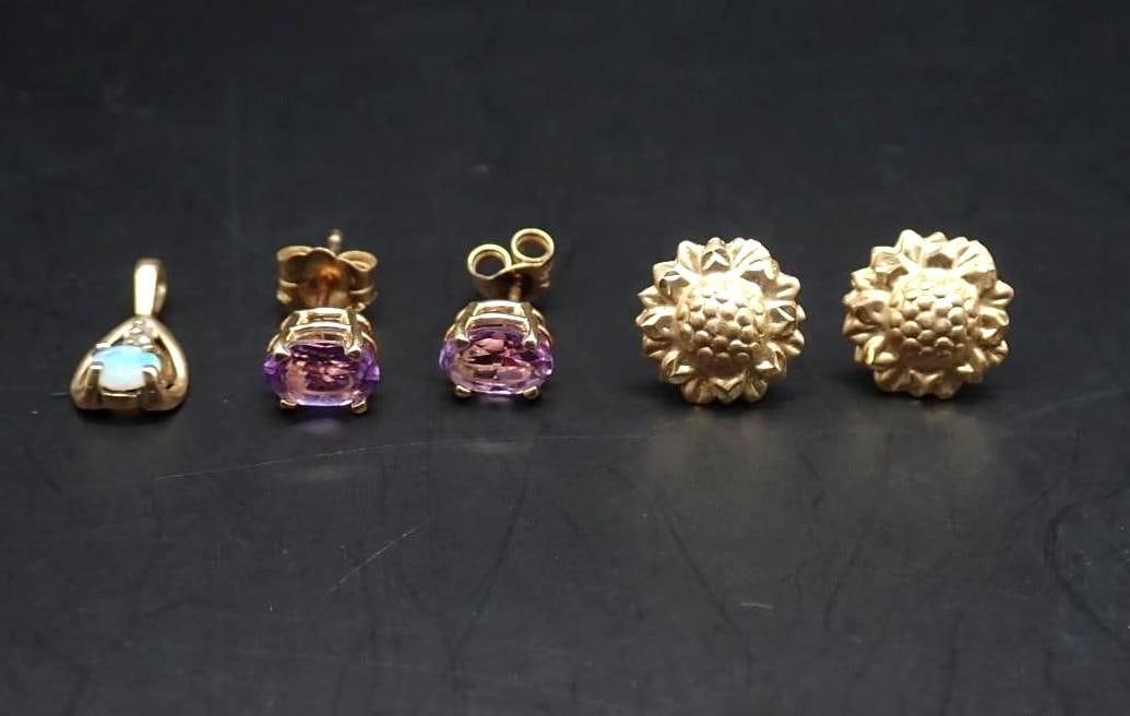 14K Yellow Gold Jewelry Lot: incl.: pair of flower stud earrings; pair of oval cut amethyst stud earrings; diamond and opal pendant; 1.59 grams total weight