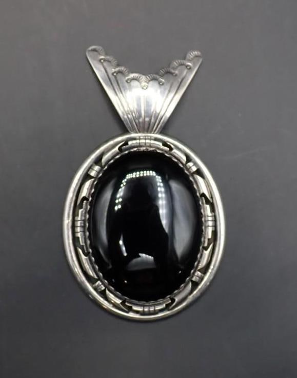 Native American Sterling Silver and Onyx Cabochon Pendant: 44mm in width x 74mm overall height; the onyx 30mm x40mm; signe on the back "AF"