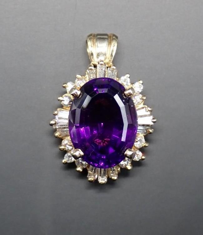 14K Yellow Gold, Diamond and Amethyst Pendant: 14.8mm x 11.2mm amethyst surrounded with (12) 1.5mm x 2.75mm+/- baguette cut diamonds and (12) 2mm+/- round cut diamonds; 25.85mm overall length; 7.0 grams total weight
