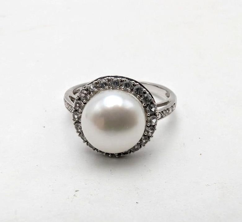 14K White Gold, White Topaz and Pearl Ring: 9.5mm pearl surrounded with (20) 1.5mm+/- white topaz and (2) 1mm+/- white topaz on the shoulders, size 7.5, 3.32 grams total weight