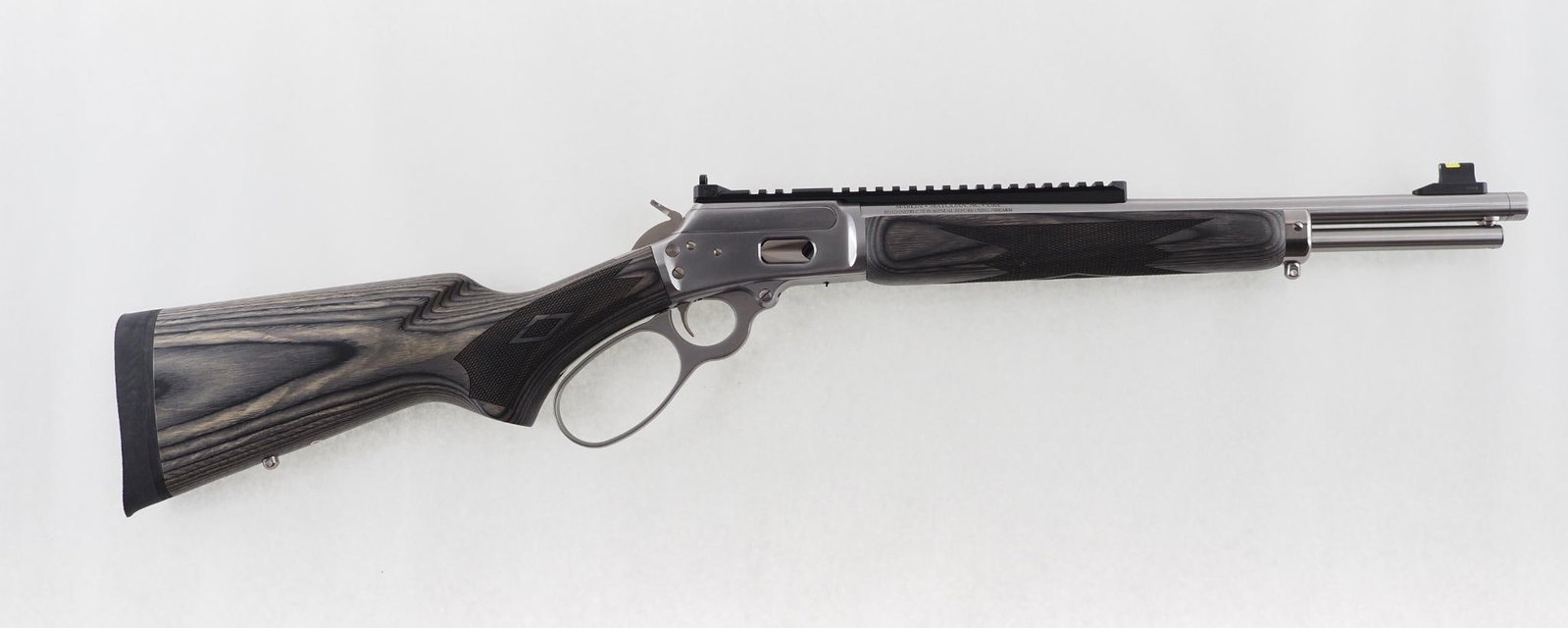 Marlin 1894 Rifle: SN: RM1033555 Cal: .357 Magnum Action Type: Lever Action Barrel Length: 16.1" Sights/Optics: adjustable rear peep sight, fiber optic front sight Stock: checkered laminated hardwood Finish: stainless