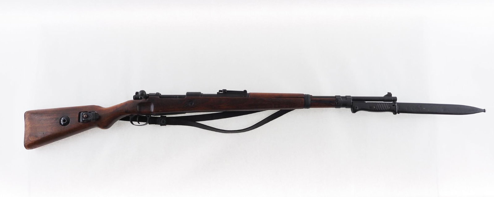 German Mauser 98 Rifle: SN: 4693 Cal: 8mm Mauser Action Type: Bolt Action Markings: "(WWII German acceptance stamp) / duv / 42" over breech, import mark on barrel behind muzzle, WWII German acceptance stamps on barrel near b