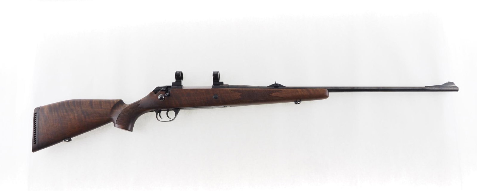 Voere Titan II Rifle: SN: 885880 Cal: 7mm Rem. Mag. Action Type: Bolt Action Barrel Length: 26" Sights/Optics: 25mm scope rings, iron sights Stock: checkered walnut Finish: strong blue Bore: excellent Overall Cond: very