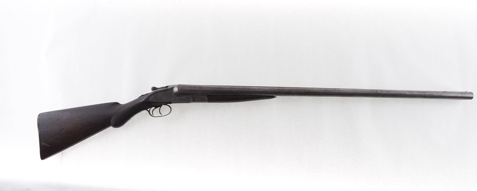 L.C. Smith Side by Side Shotgun: SN: 35538 Year of Mfg: 1920 Cal: 10 Ga. Action Type: break action Barrel Length: 32", modified and improved cylinder Sights/Optics: beaded front sight Stock: checkered walnut stock, chip out of