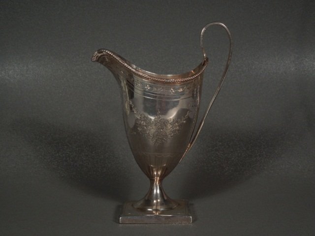 Silver Creamer Peter & Ann Bateman, 1794: Peter & Ann Bateman, 1794, helmet form engraved with a monogrammed reserve within floral swags with beaded rim and reeded handle. Weight 4 1/2 oz. Measures 5 7/8" tall
