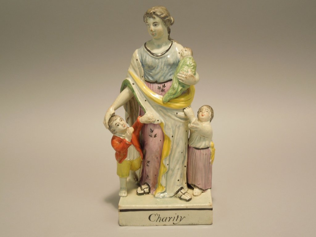 Staffordshire Pearlware Figure Circa 1800: Early 19th century Staffordshire pearlware figure of charity; circa 1800; measures 8 1/2"; good overall condition but is missing tip of thumb.