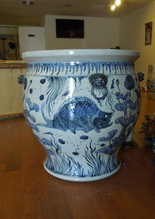 Massive Old Chinese Blue and White Jardiniere: Massive Old Chinese Blue and white hour glass form Jardiniere with wonderful molded fish scenes and foo dog handles; some of the rings on handles are chipped or missing but consistent with age does no