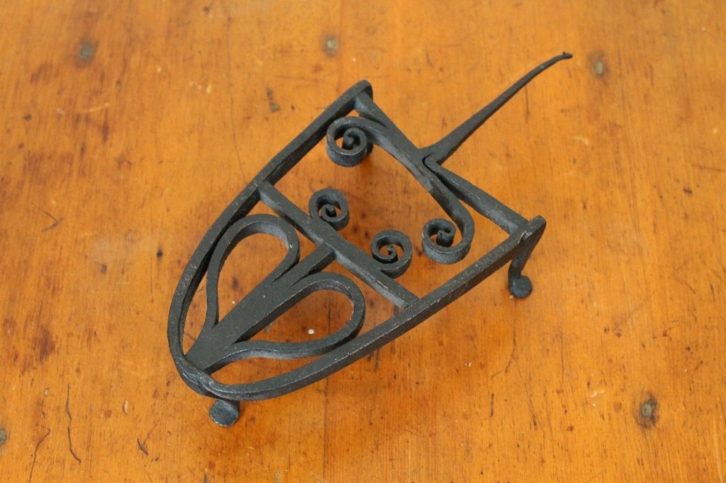 American 18th century Iron Heart Trivet: American 18th century Iron Heart Trivet with penny feet; measures 10 1/4". Good condition