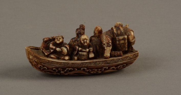Signed Chinese Ivory Netsuke Figures on Boat c1900: Chinese Ivory Netsuke Figures on Boat with horse and baggage. Carved waves surrounding boat. Signed on bottom.; measures 3.25 "( 7.25 cm)