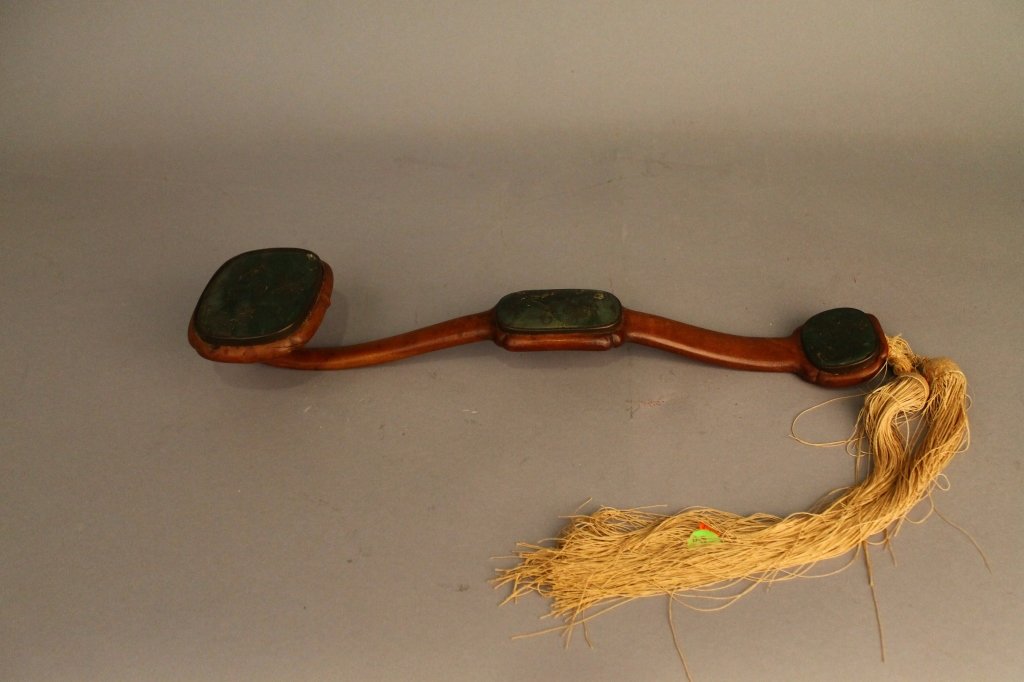 Chinese Jade Ruyi Scepter: Chinese hardwood and jade ruyi scepter, with carved jade inlays, with detailed floral motifs, and the natural wood grain showing. Length 17.5" (43 cm) has silk tassle attached. Wonderful condition.