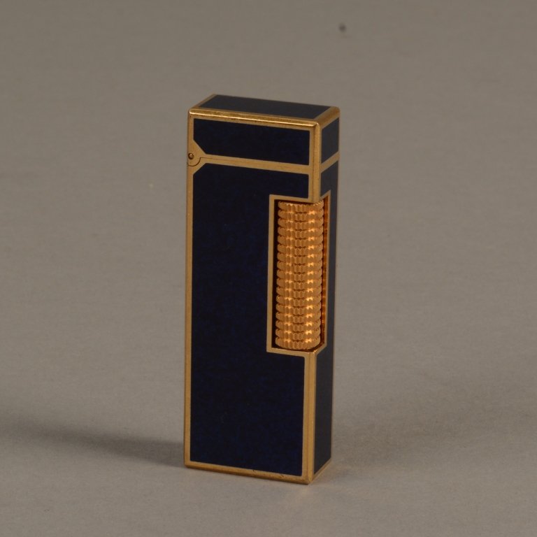 Vintage Black Lacquer Rollagas Dunhill Lighter: Vintage Black Lacquer Rollagas Dunhill Lighter - A very nice Rollagas Dunhill lighter with black lacquer panels and Gold plated surround. Circa 1971. Made in Switzerland; measures 2.5" x 1"( 6.5cm x 2