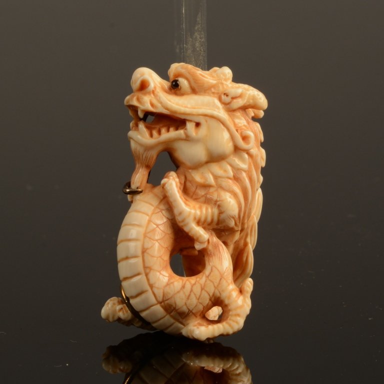 Antique Chinese Carved Ivory Dragon Netsuke Signed: Antique Chinese Carved Ivory Dragon Netsuke mounted in silver as a brooch or pendant. Wonderfully carved with black onyx eyes. Signed seal mark , measures 2" x 1.5" ( 5cm x 4cm)