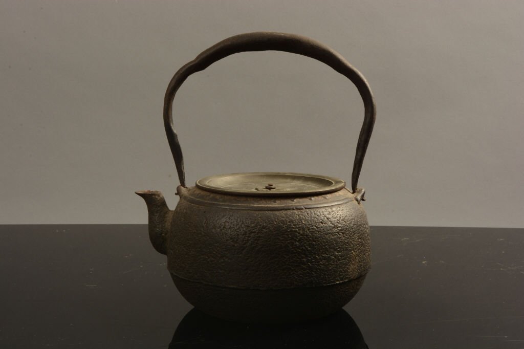 Antique Japanese Iron and Bronze Archaic Teapot: Antique Japanese iron and bronze teapot with an Archaic form; measures 9 1/2" tall.
