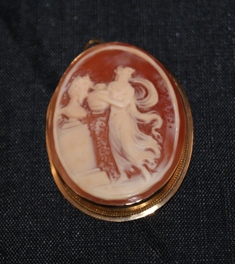 Artisan Carved Oval Shell & 585 Gold Cameo Brooch: Woman with urn design in 585 gold bezel. Bezel provides option to be either a brooch or pendant. Carved into back, "ALBANESE". Total weight of pendant: 7.56g. Measures approx: 1.625" tall x 1.25" wide