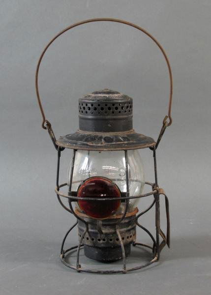 CPR LANTERN: - vintage Canadian Pacific Railway lantern with circular red glass pane. Height: 15 in.