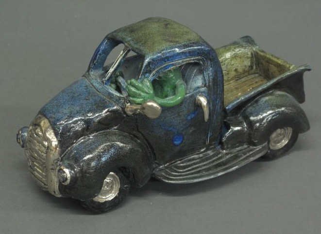 JORDAN VAN SEWELL CLAY SCULPTURE: depicting a pick up truck being driven by a frog. Length: 9 in.