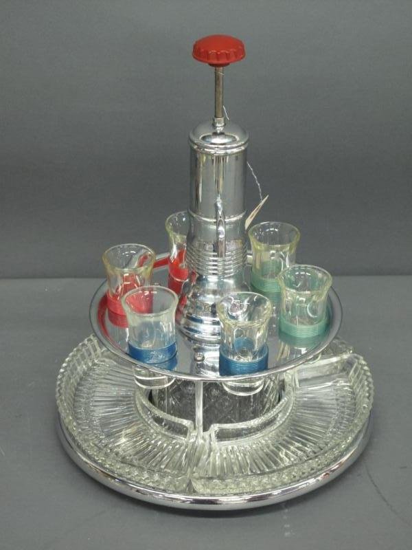 CHROME LIQUOR DECANTER SET: hand pump, with 6 shot glasses and and lower 3 section server.