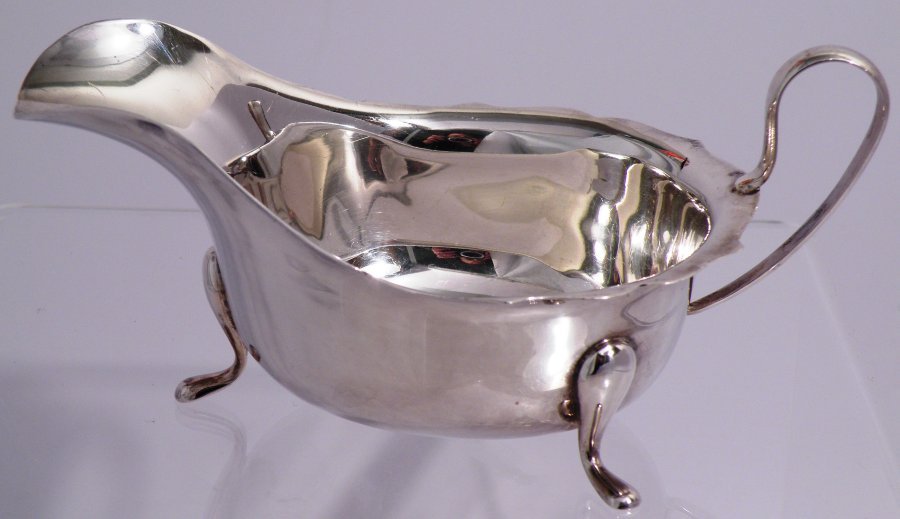 SHEFFIELD ENGLAND STERLING SAUCE BOAT: Your winning bids will arrive exactly as shown in picture in lot catalog. This is marked on the side EV, Crown, Lion Passant, P 3.28 ozt. SHEFFIELD ENGLAND STERLING SAUCE BOAT IB (AA IB) Charity: Proc