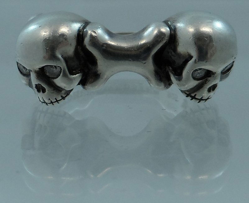 STEPHEN WEBSTER DOUBLE SKULL STERLING DIAMOND: Buyer will receive the exact ring shown here. This ring is sterling silver with diamonds in the eye sockets of each skull. We believe this ring to be part of Stephen Websters Boyfriend Collection. It