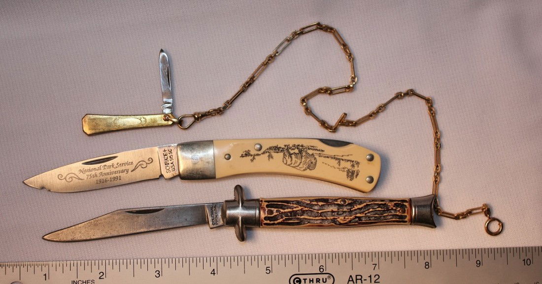 LOT OF THREE POCKET KNIVES: Lot consists of one Colonial USA made single blade, one Schrade National Park Anniversary knife, and one small unmarked pen knife with gold filled chain. The Colonial Handle is made of plastic, not st