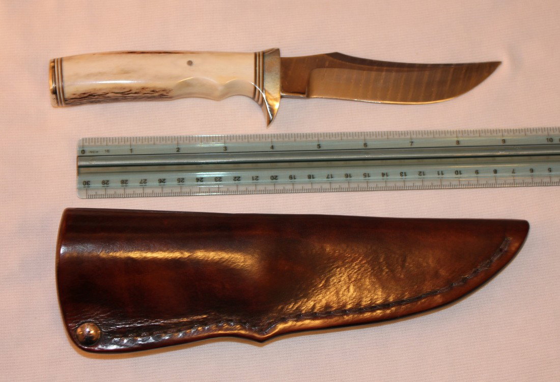 AMAZING DAMASCUS SKINNER HANDMADE KNIFE: Beautiful handmade Damascus blade knife with Stag handle grips. Knife is 9 ½ inches overall, with a 4 ¾ inch blade, and nickel silver guard. Sheath is made from very thick 10 oz molded leather. Come