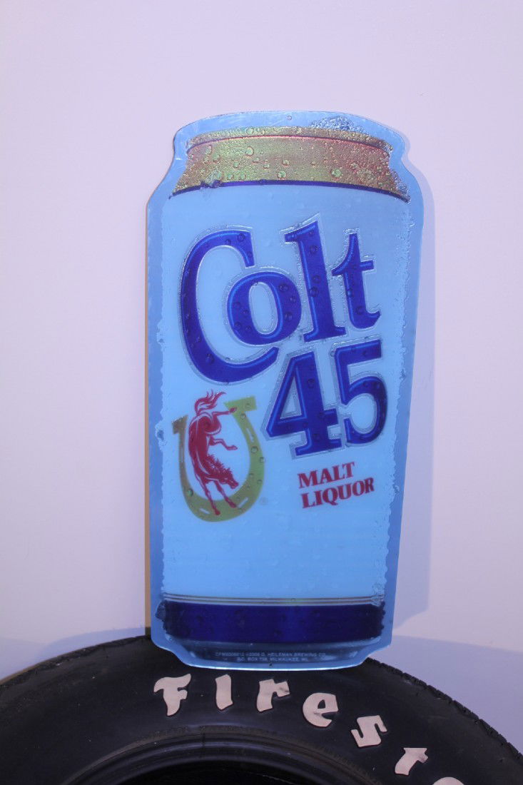 COLT 45 BEER ADVERTISING SIGN: Commercial Colt 45 malt liquor advertising sign dated 2009 made of plexiglass. Item is new and unused and is still covered in clear blue shrink wrap from the factory. Measures 22 ½’ by 10”. This