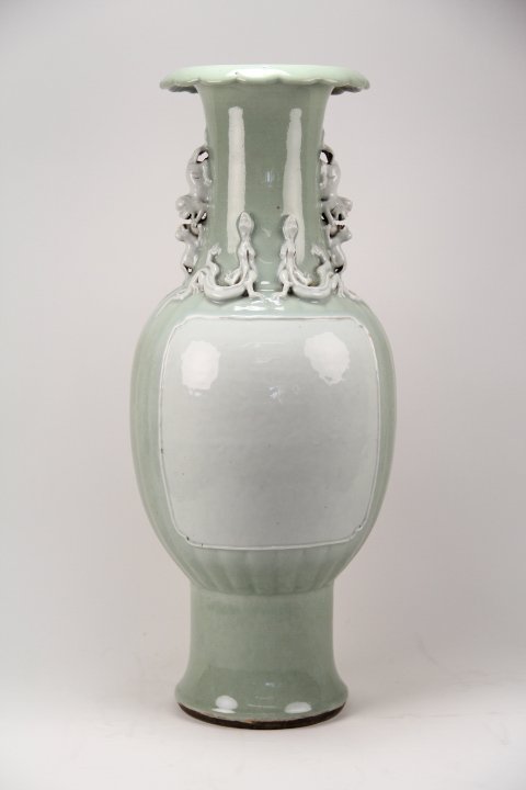PEA GREEN GLAZE GLAZE VASE: Qing Dynasty pea green glaze vase with Sunflower shaped mouth and carving of four dragons and four lions.