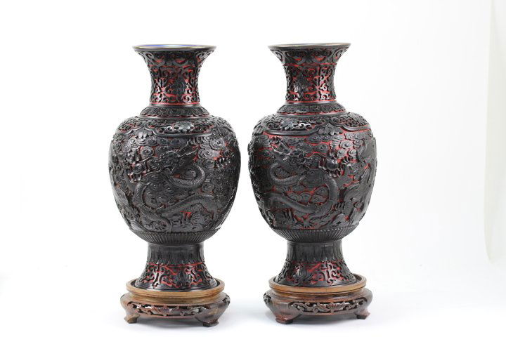 CARVED BLACK CINNABAR ON RED VASES (PAIR): Pair of black cinnabar red vases carved of a dragon and cloud. Republican. Comes with wood bases.