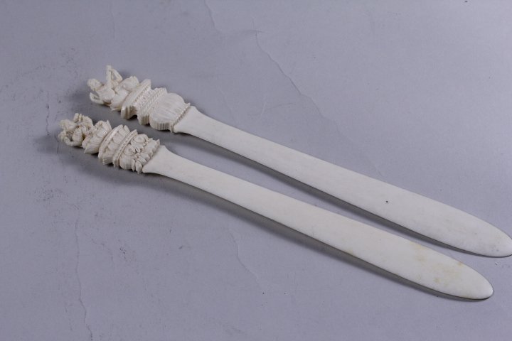 PAIR OF CARVED IVORY ENVELOPE OPENER: A pair of ivory envelope opener carved with Indian figures.