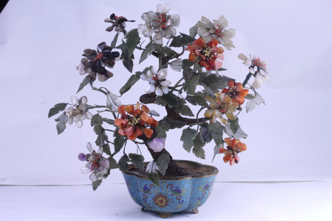 FINE CLOISONNE CARVED POT: Fine cloisonné pot with various stone flowers carved. Later Qing Dynasty . in good condition a small repair .