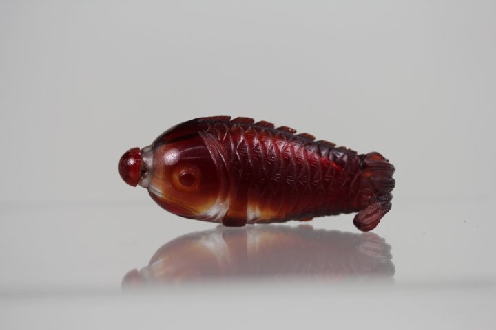 OLD PEKING RED GLASS SNUFF BOTTLE WITH FISH SHAPE: Old peking red glass snuff bottle carved with fish .Good condition. H-8.0cm