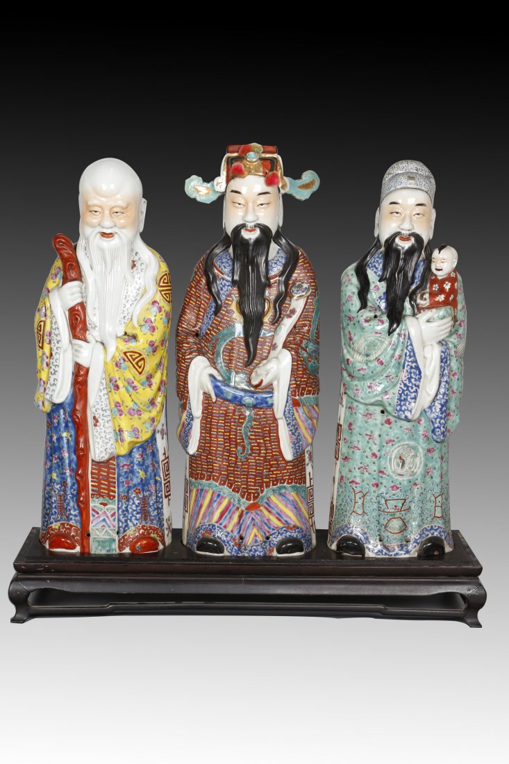 Set of Three Famille Rose Porcelain Immortals Statues.: Made by Zhu, Maosheng. This beautiful and large-sized porcelain set of “Fu” “Lu” “Shou” gods each represents happiness, wealth, and longevity. Comes with mahogany stand. Come with marks. C