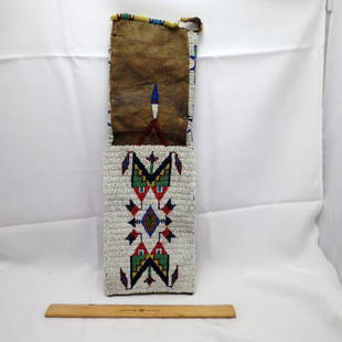 Native American Collectibles: Original 1860's Indian Beaded Tabaco bag. Leather, beautiful bead work, has some condition issues on one side of leather, but beading is in excellent condition, see pictures. Approximately 19 inches