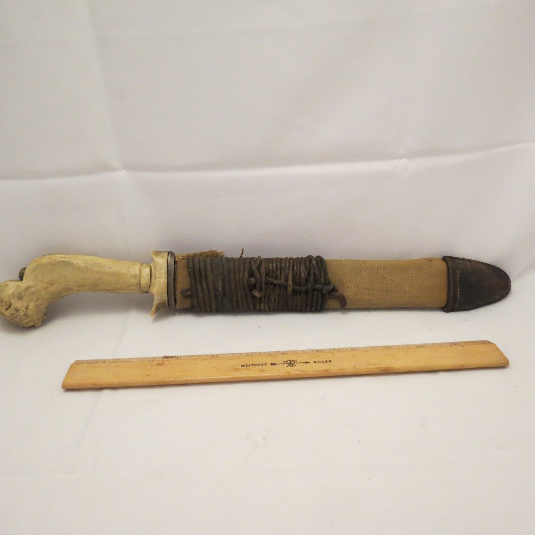 Edged Weapons: Military Trench Knife. Straight single edged overall length 16 inch blade with 5 inch false edge and channel in blade.Pretty sure blade is from a bayonet. Antler grip. Blade showing overall discolorat
