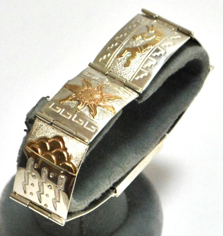 Navajo 12k Gold Filled Sterling Silver Link Bracel: Navajo 12k Gold Filled Sterling Silver Link Bracelet - Alonzo Mariano Measures 8-1/4" long by 3/4" wide. Designs present: Lizard, Spiral, Kokopelli, Sun, Storm Clouds, Sea Turtle, Badge. Weight: 30.2g